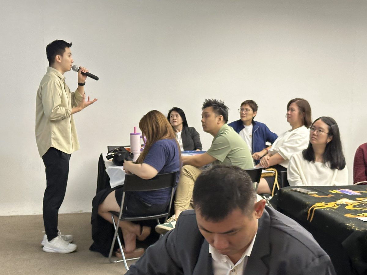 A speaker with a microphone addressing the room